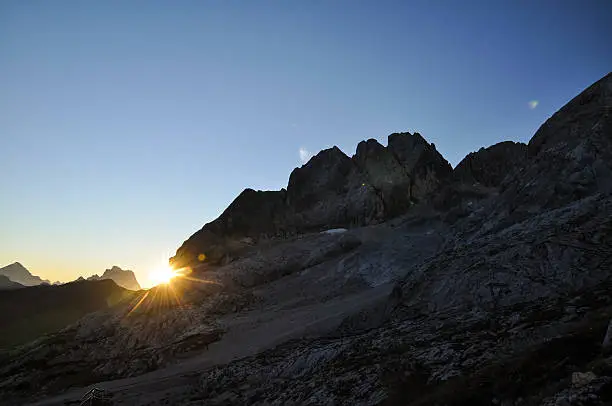 Stunning sunrise photo shot while hiking up Mount Marmolata (Marmolada). Marmolata is the highest mountain in the Dolomites (3343m). The two mountains in the background are Monte Antelao and Monte Pelmo.