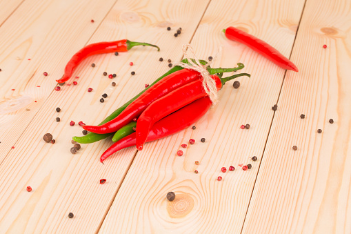 Hot chili pepper on wooden texture. Whole background.