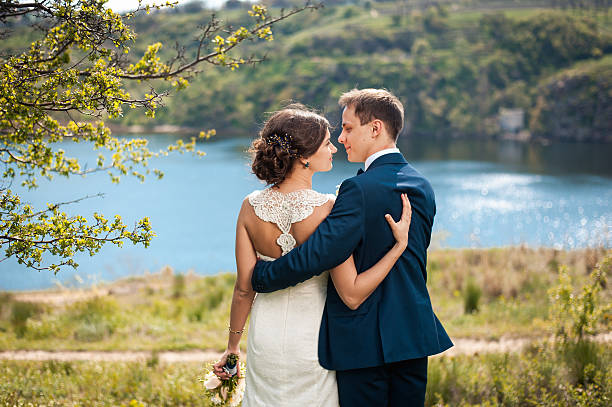 istock Bride and groom walking at the river 520971160