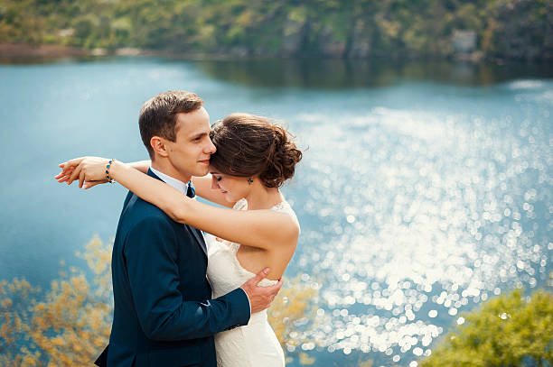 istock Bride and groom walking at the river 520971290