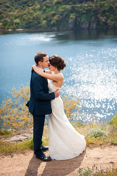 istock Bride and groom walking at the river 520971314