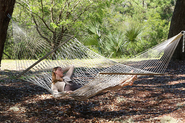Woman relaxing in Hammock stock photo