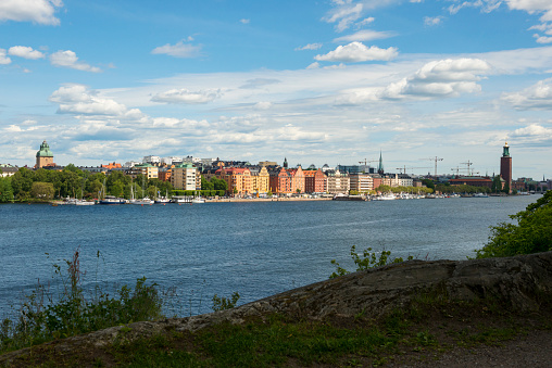 Summer day on Långholmen, an island in Stockholm, Sweden. On the right is the Stockholm city hall.