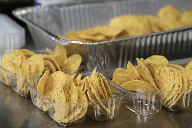 istock Preparing Servings Assembly Line Concession Nachos Tortilla Chips Snack Food 520973578