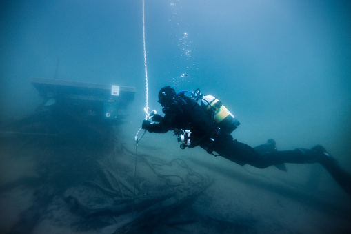 Diver working on dark waters at Finland in lake Melkutin