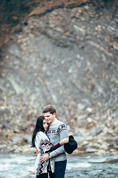 istock guy and girl along a mountain river 520973986