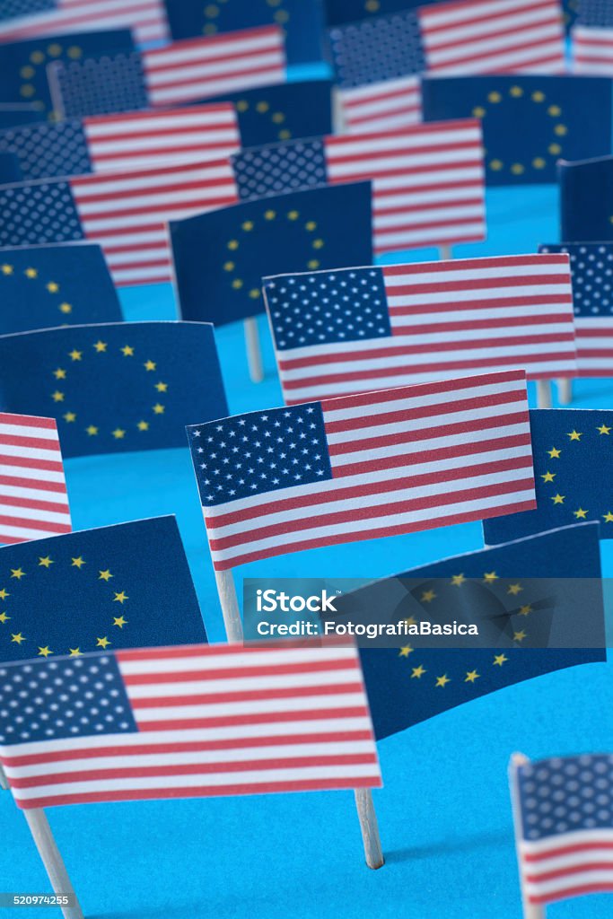 American and european flags Lots of paper made american and european flags over blue background Abundance Stock Photo