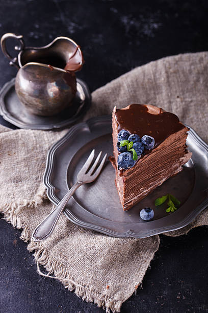 istock Piece chocolate cake from chocolate pancakes with icing 520974446