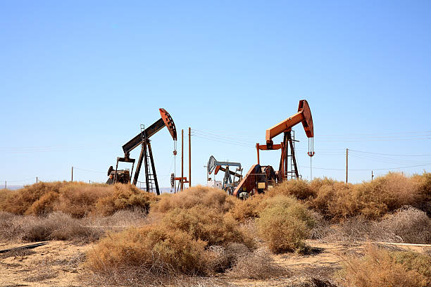 istock Six Pumpjacks Working In The Oil Field 520976077