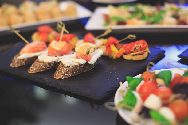 istock Beautifully decorated catering banquet table with different food snacks appetizers 520976192