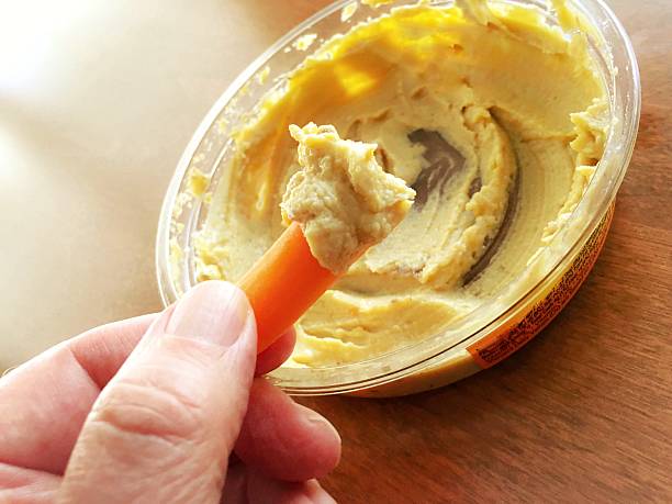 Carrot dipped in hummus