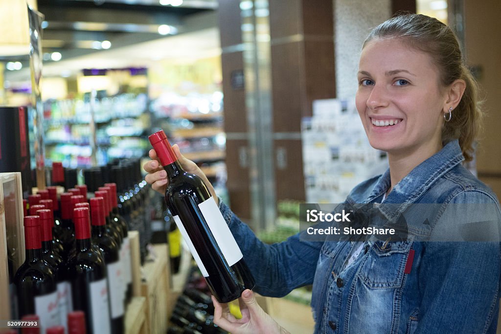 Woman holding wine bottle Side View Stock Photo