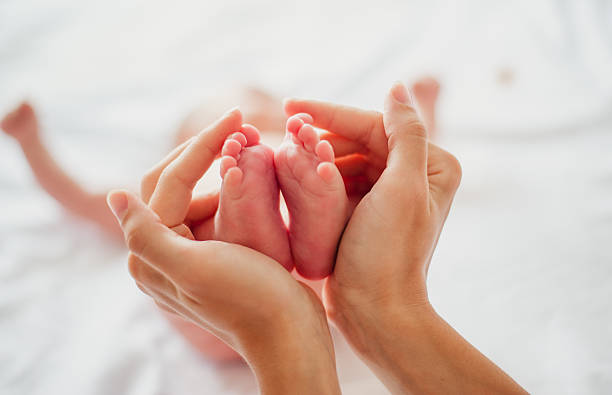 istock Feet baby in mother's arms 520977506