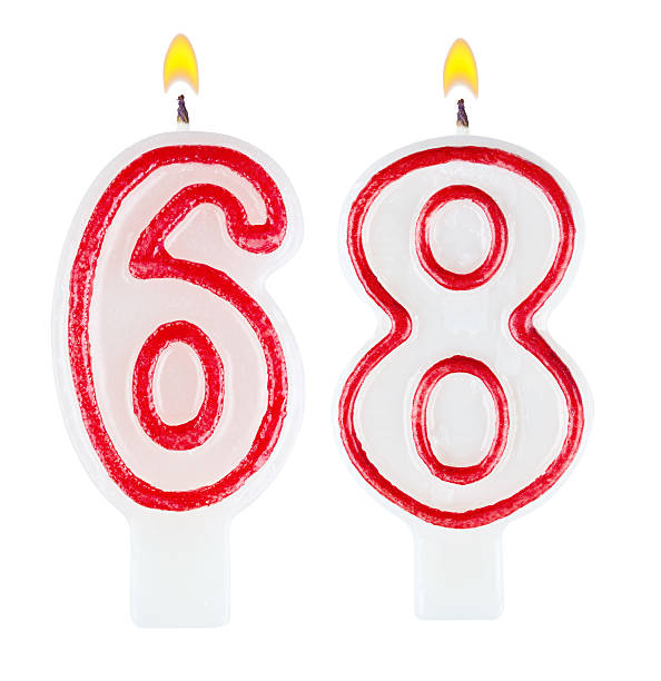istock Birthday candles number sixty eight isolated on white background 520977979
