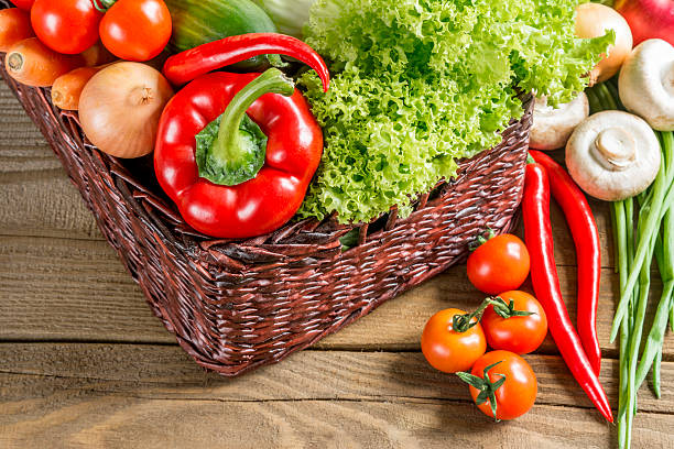 istock Wicker basket with fruits and vegetables on the table 520978606