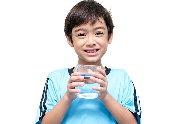 istock little boy drinks water from a glass 520979257