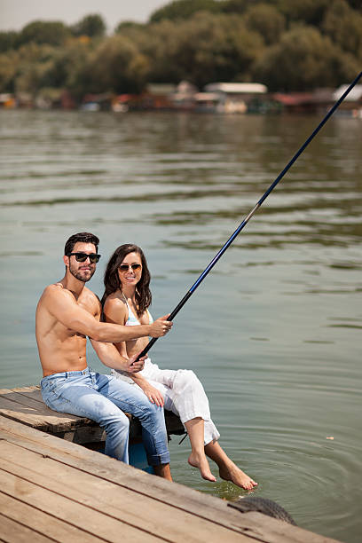 istock young couple fishing,selective focus 520980608