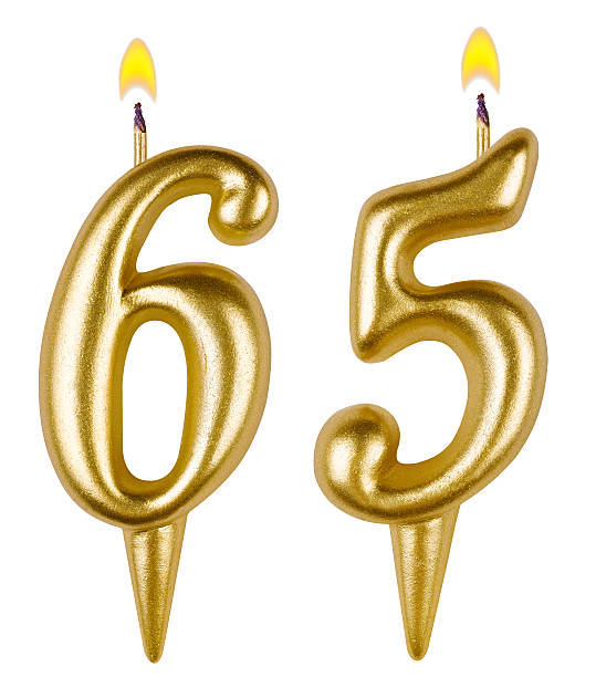 istock Birthday candles number sixty five isolated on white background 520980823