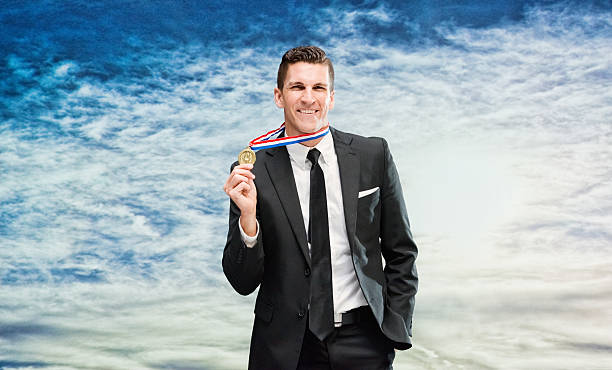 istock Smiling businessman showing medal 520982568