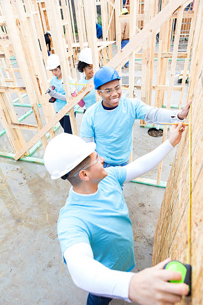 istock Men enjoy working on charity home 520983176