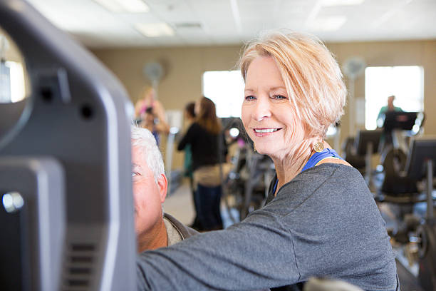 istock Senior couple use exercise machine at gym 520983530