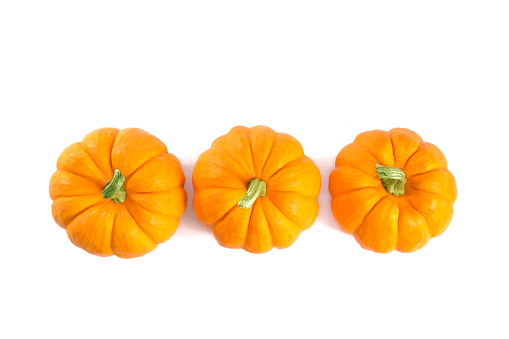 Top view of decorative orange pumpkins, isolated on white background, for Thanksgiving day or Halloween