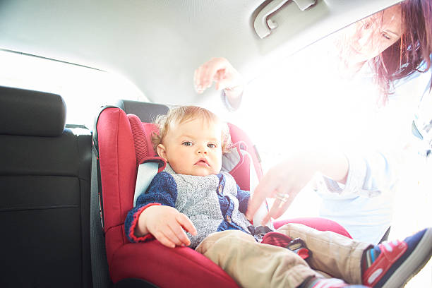 istock Baby boy being fastened in car seat 520984008