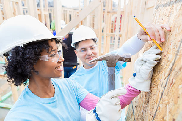 istock Woman uses hammer at construction site 520984106