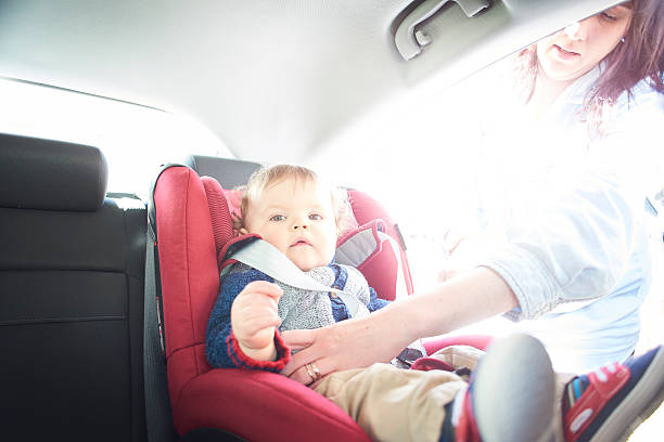 istock Baby boy being fastened in car seat 520984194