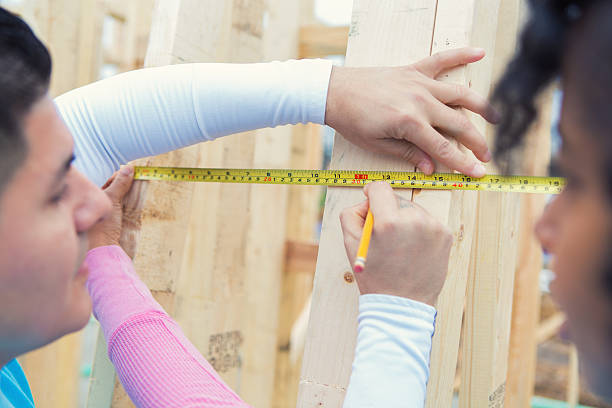 istock Volunteers measure boards at construction site 520984444