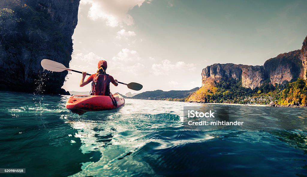 Lady with kayak Lady paddling the kayak in the calm tropical bay Kayaking Stock Photo