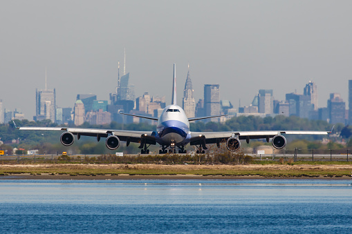 New York, USA - April 30, 2012: Boeing 747 China Airlines Cargo lines up on the runway at John F. Kennedy International Airport in New York, USA on April 30, 2012 with Manhattan in the background. China Airlines is the flag carrier of the Republic of China - commonly known as Taiwan.