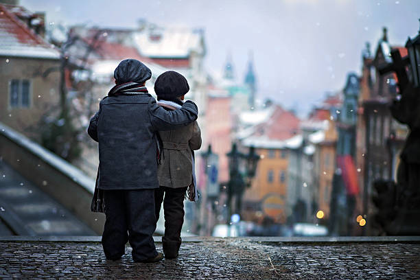 istock Two kids, standing on a stairs, hugging, view of Prague 521000287