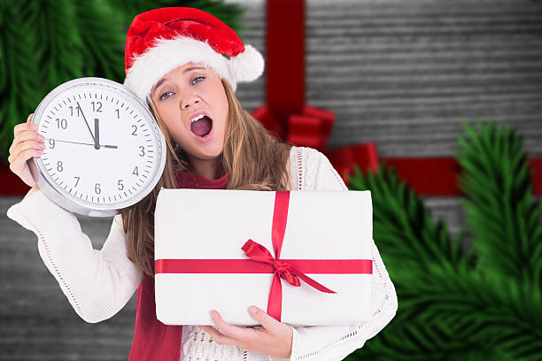 istock Composite image of festive blonde showing a clock and gift 521000825