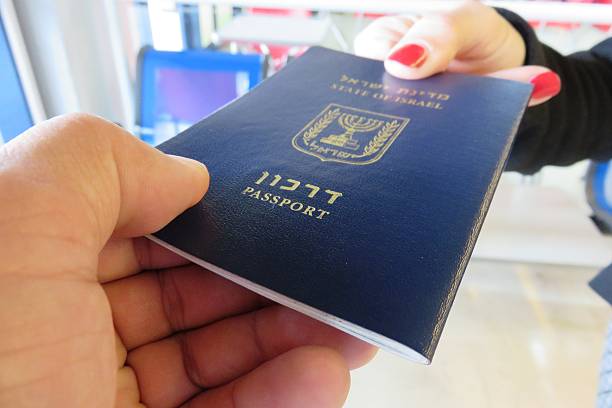 giving-passport - customs official examining emigration and immigration document stock-fotos und bilder