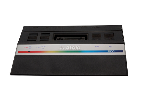 Adelaide, Australia - October 27, 2014: A studio shot of a vintage Atari 2600 gaming console. Initially released in 1977, Atari is credited with popularizing microprocessor-based hardware and cartridges with game code