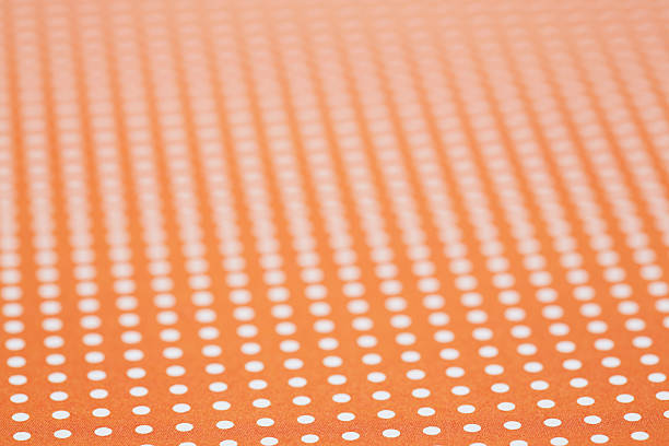 istock Close up of orange and white spotted textile 521004161