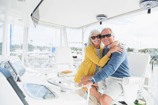istock Senior couple embracing on boat wearing sunglasses 521004380