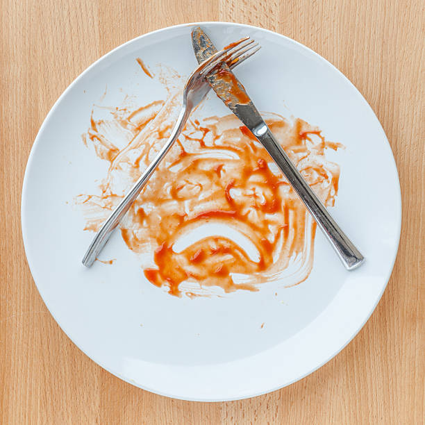 istock Knife and fork over the dirty plate after finished meal, 521004404