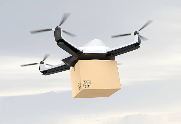 istock Autonomous unmanned drone delivering cardboard box in the sky 521004848