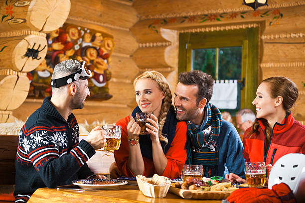 istock Friends having lunch and drinking beer after skiing 521005827