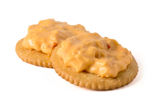 Pimento Cheese spread on Crackers, isolated on white.