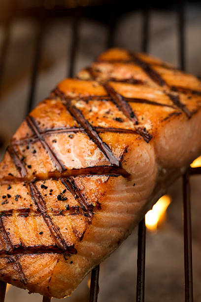 istock Grilled Salmon Filet Cooking on a Charcoal Grill 521006477