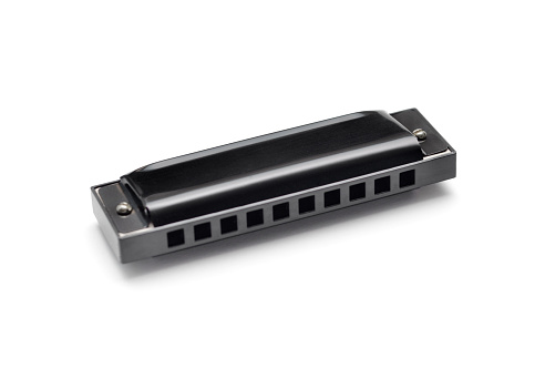 One harmonica on a white background