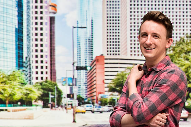 istock Smiling man standing with arms crossed 521007212