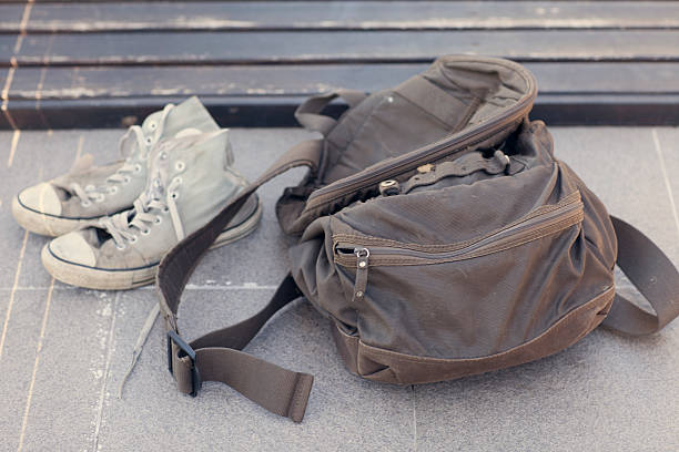 Dirty shoes and backpack stock photo