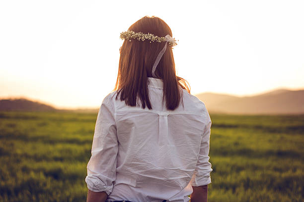 istock White shirt and green field at sunset 521009202