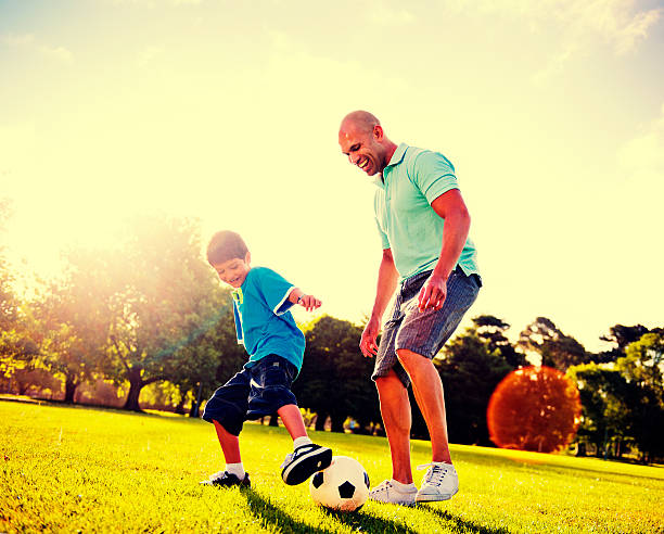 istock Little Boy Playing Soccer With His Father Concept 521009210