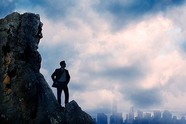 Businessman Silhouetted As He Confidently Looks Over City
