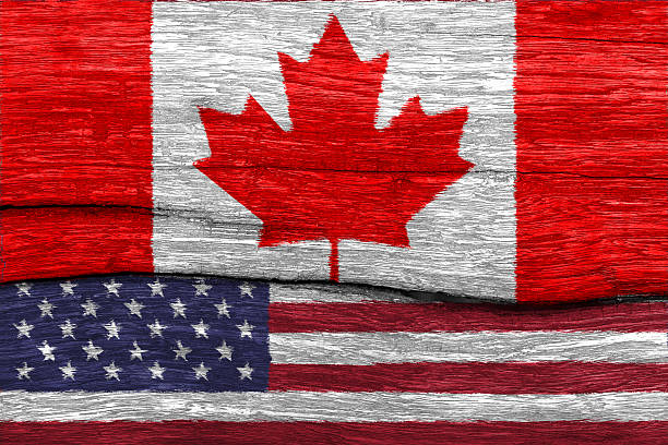 istock canada and USA flag on wood 521012406